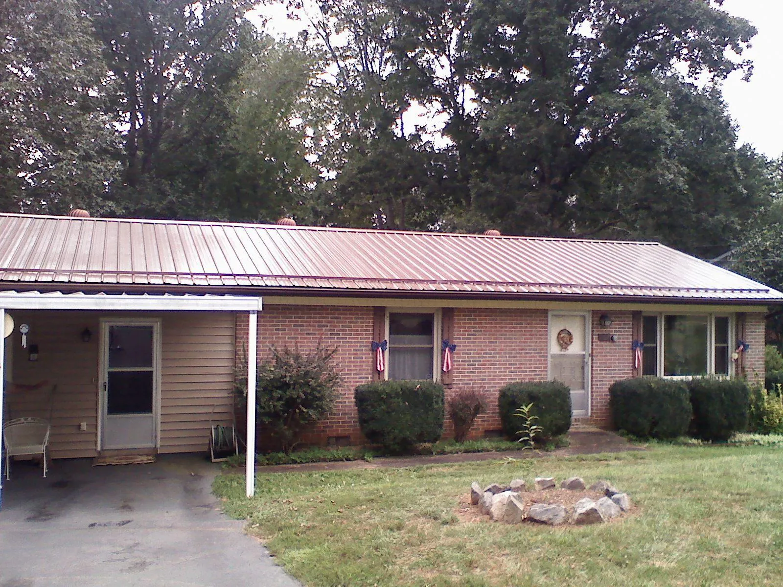 Bronze metal roof and carport on a brick ranch home — Roof Repair work by our crew in Walkerton